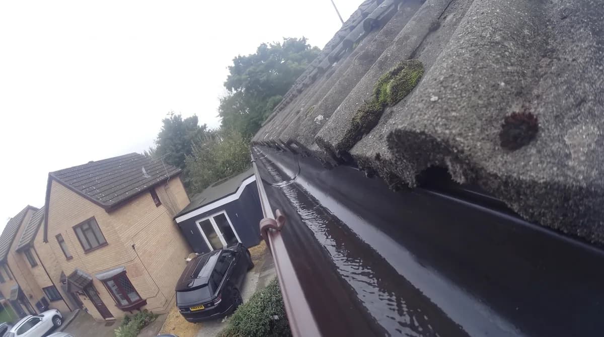 After: Moss along a gutter towards the road, then cleared